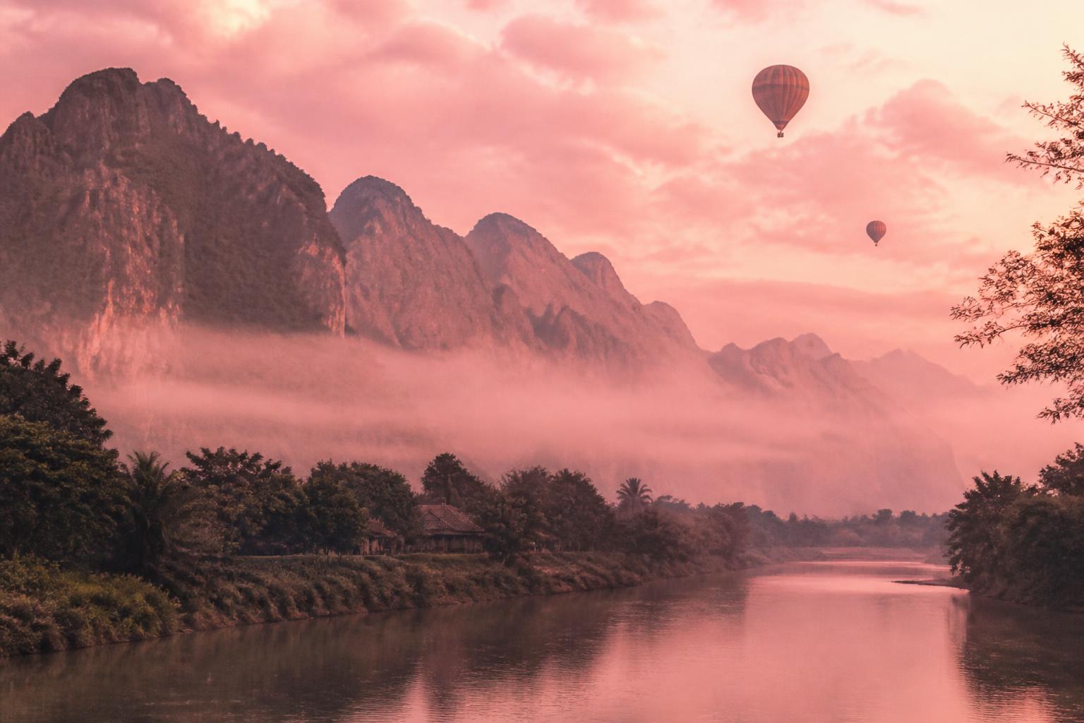 Soft pink dawn over the karst mountains of Vang Vieng, Laos